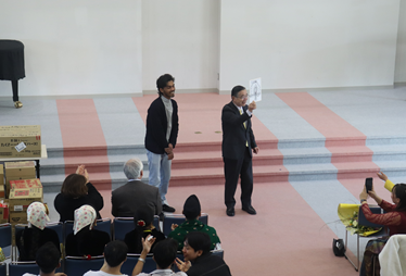 宗次先生の似顔絵を描いて渡すヤシットさん